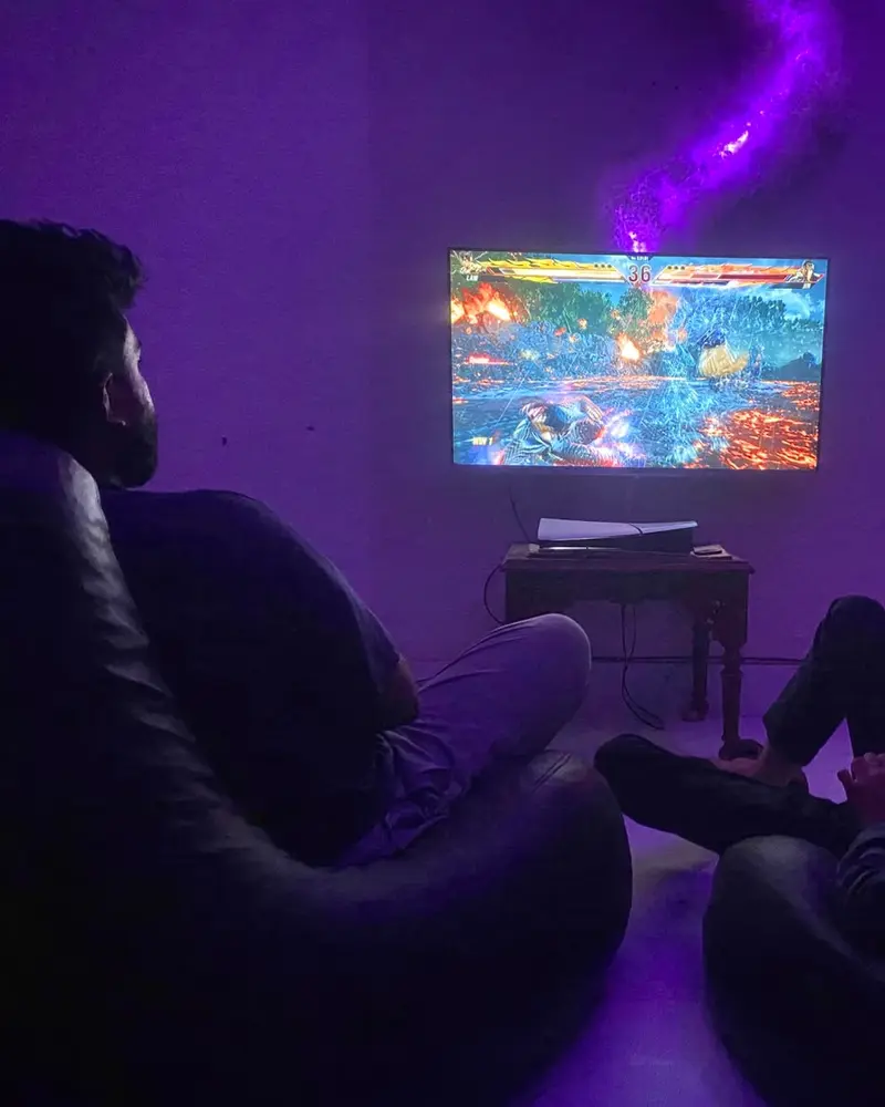 Two friends on bean bags mid-match in an ARISE room